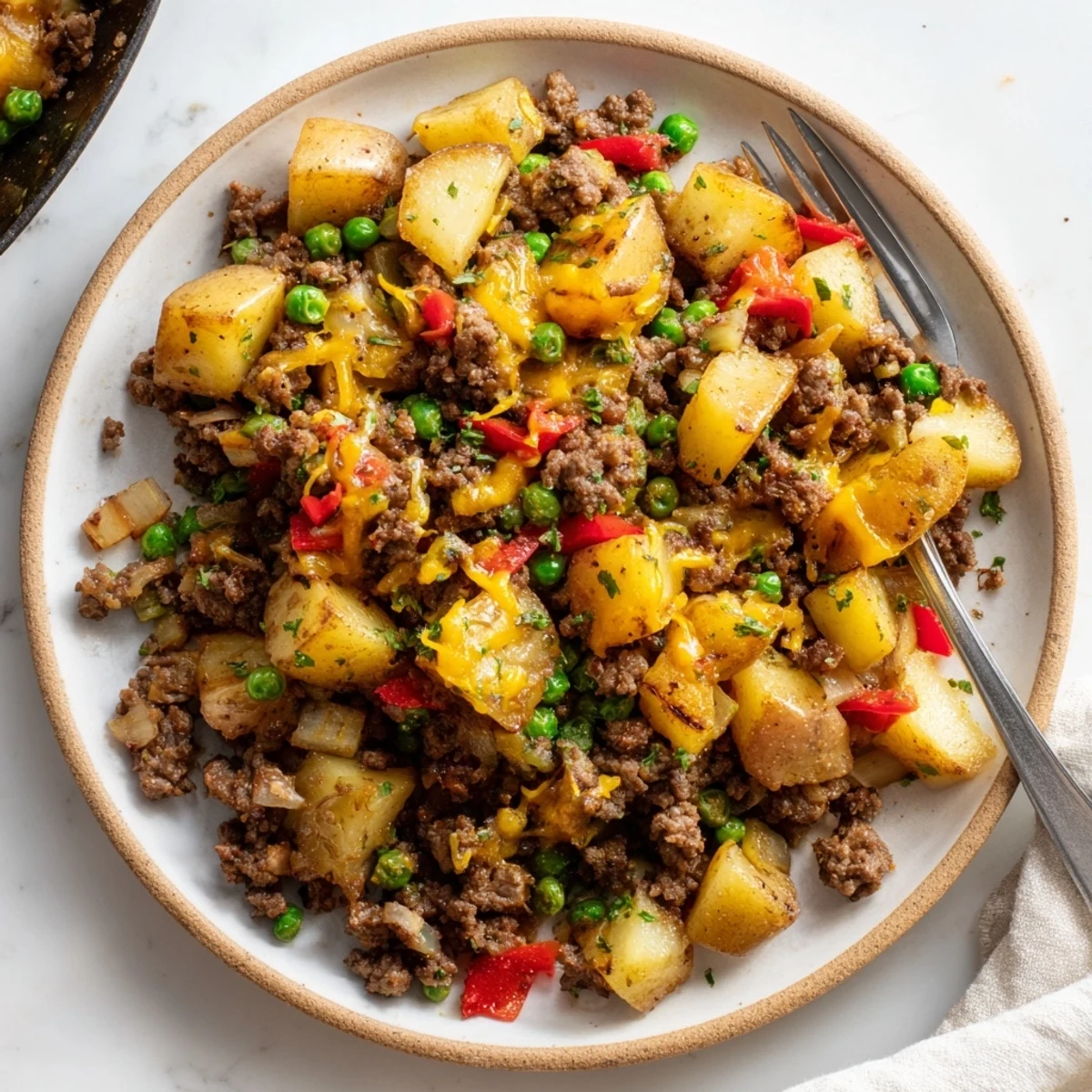 One-pan Homestyle Beef and Potato Skillet, a hearty meal with vibrant vegetables.