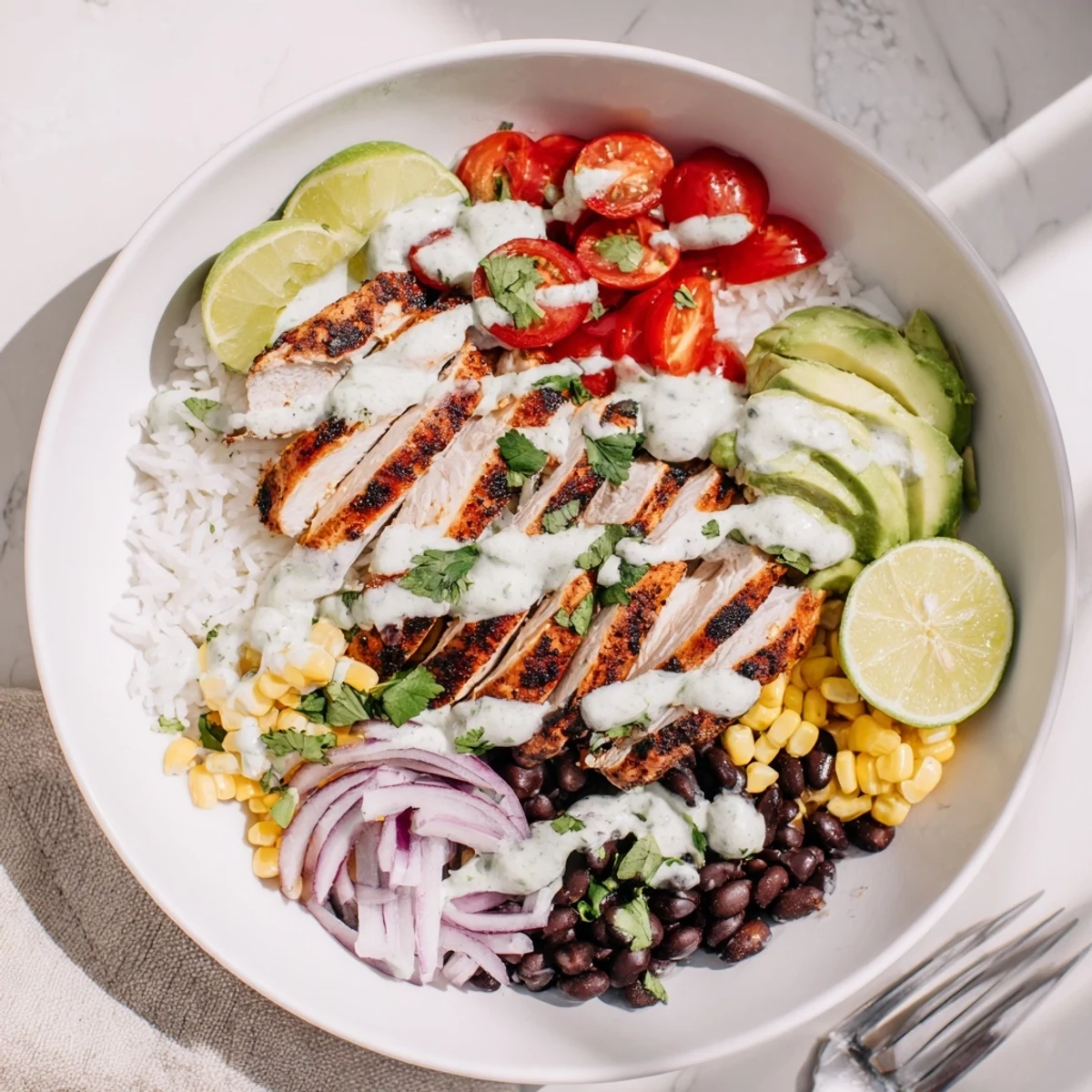 Colorful lime-marinated chicken bowls brimming with fresh ingredients and flavorful drizzle.