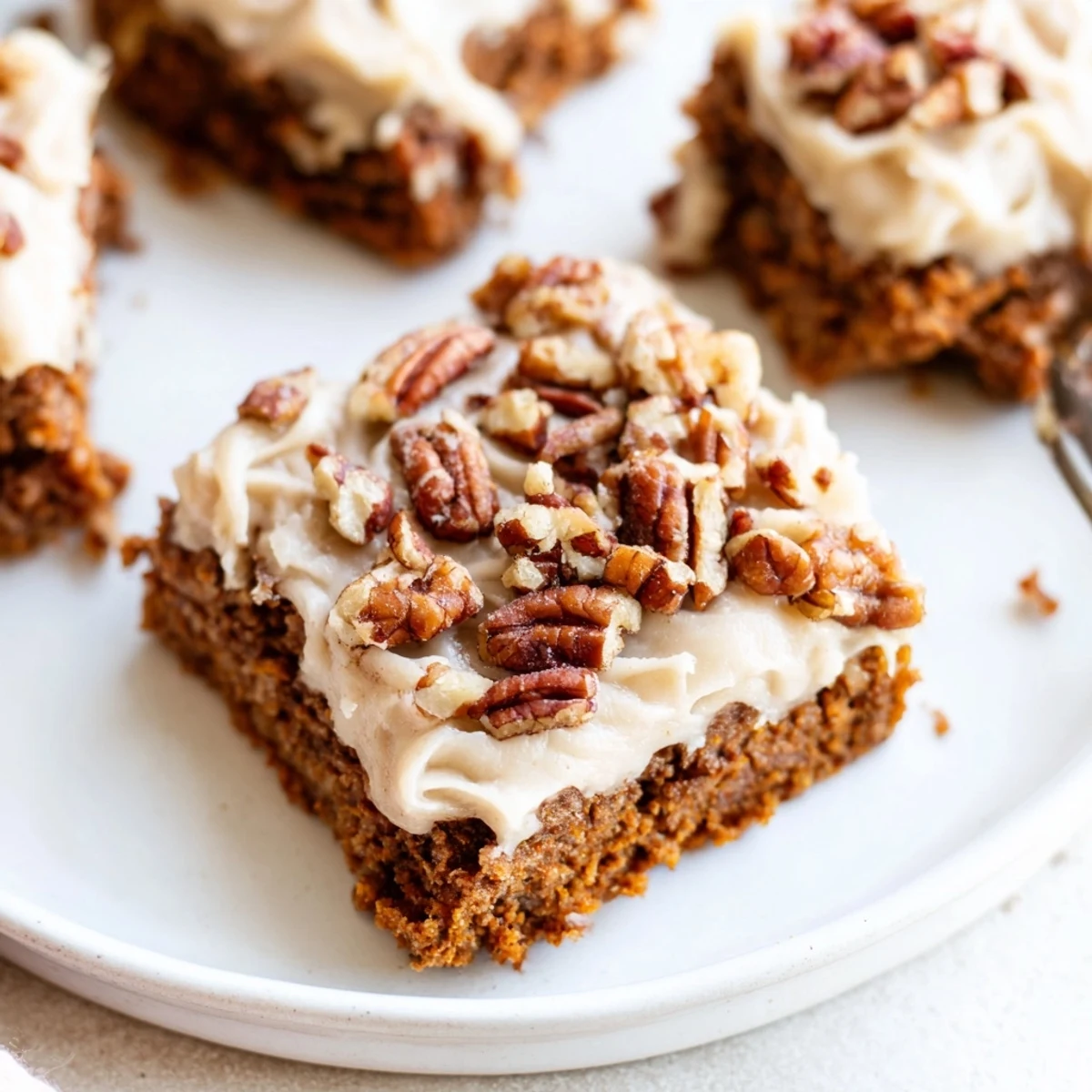 Warm, frosted pumpkin bars, a fall dessert featuring delicious brown sugar frosting up close.