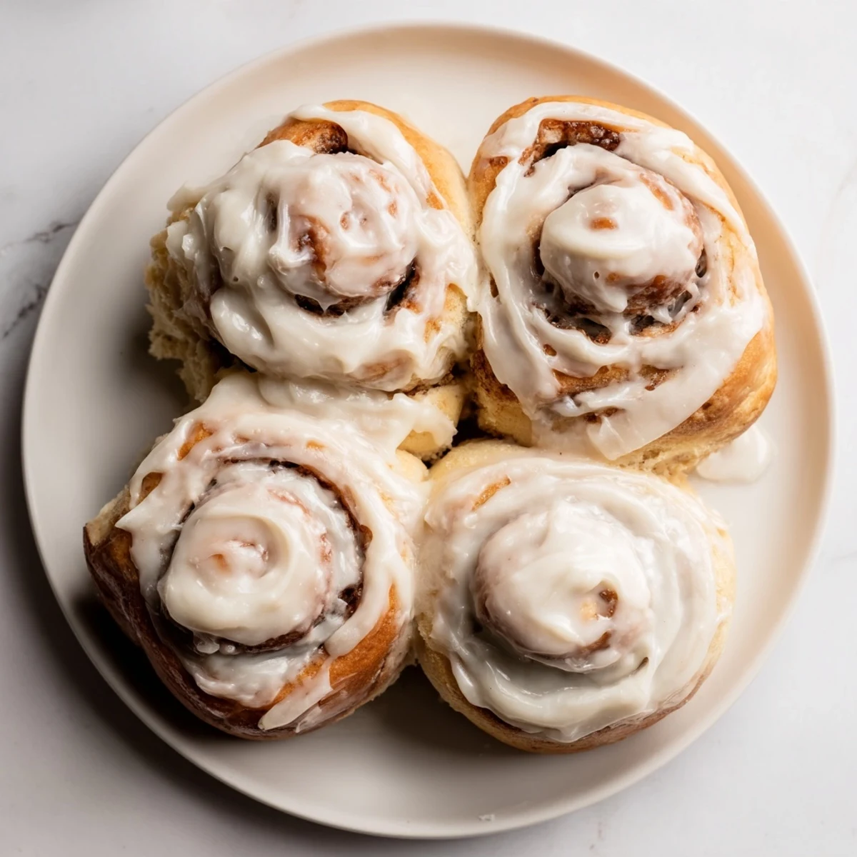 These warm, gooey TikTok Heavy Cream Cinnamon Rolls are dripping with a rich cream cheese glaze.
