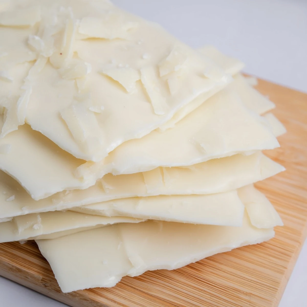 Dramatic, frozen The Arctic Tundra dessert: white chocolate "ice" with salty parmesan atop a wooden board.