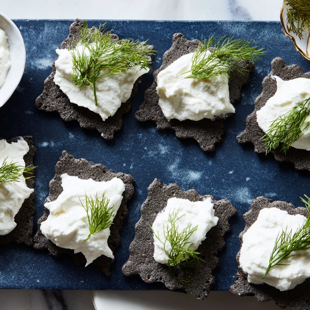 Enjoy the "Stormy Sea" appetizer; a beautiful display of goat cheese topping dark, wavy crackers.