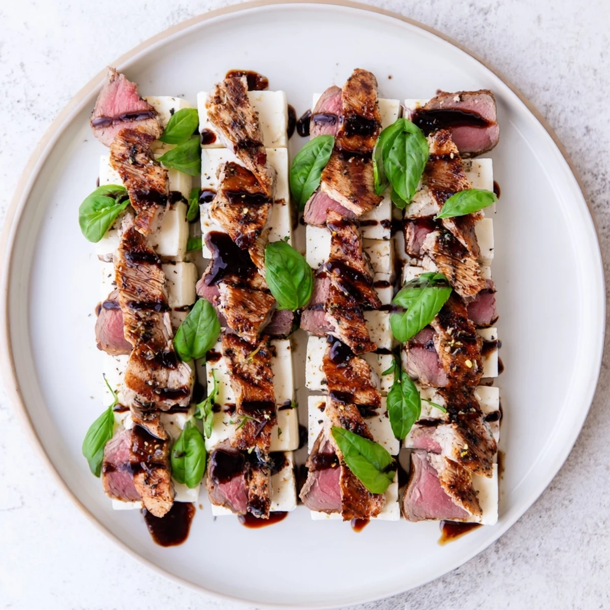 Savory Safari Stripes appetizer showcasing balsamic-glazed meats and creamy cheese strips, ready to enjoy.