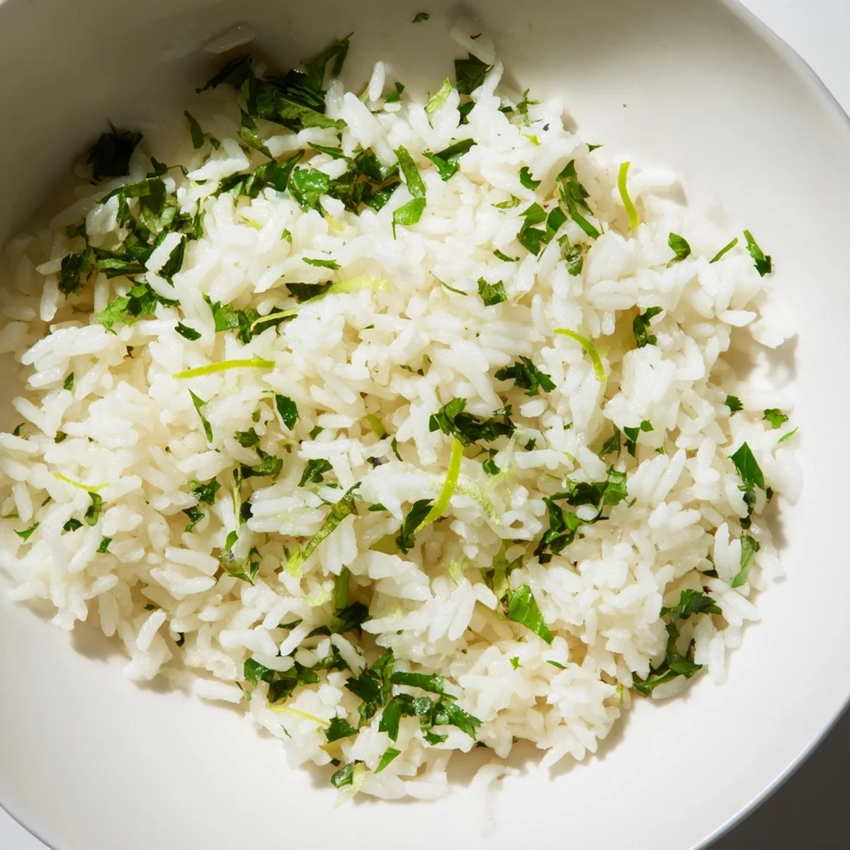 Close-up of fluffy Cilantro Lime Rice, bursting with citrus aroma and fresh cilantro flavor.