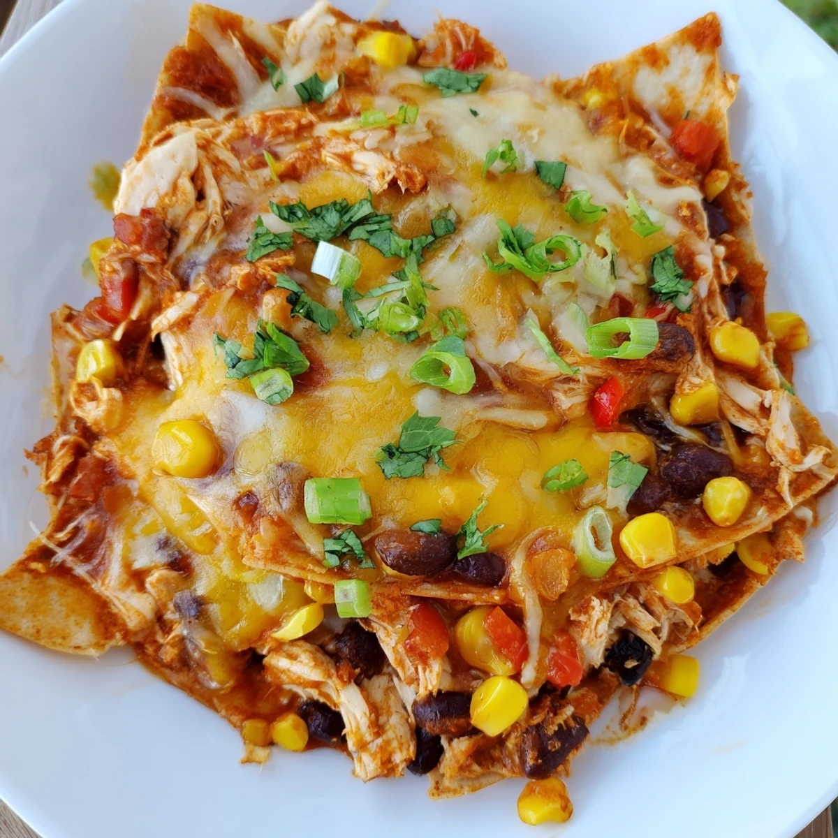 Golden cheese covers a hearty Chicken Enchilada Skillet with a rich enchilada sauce and flavorful veggies.