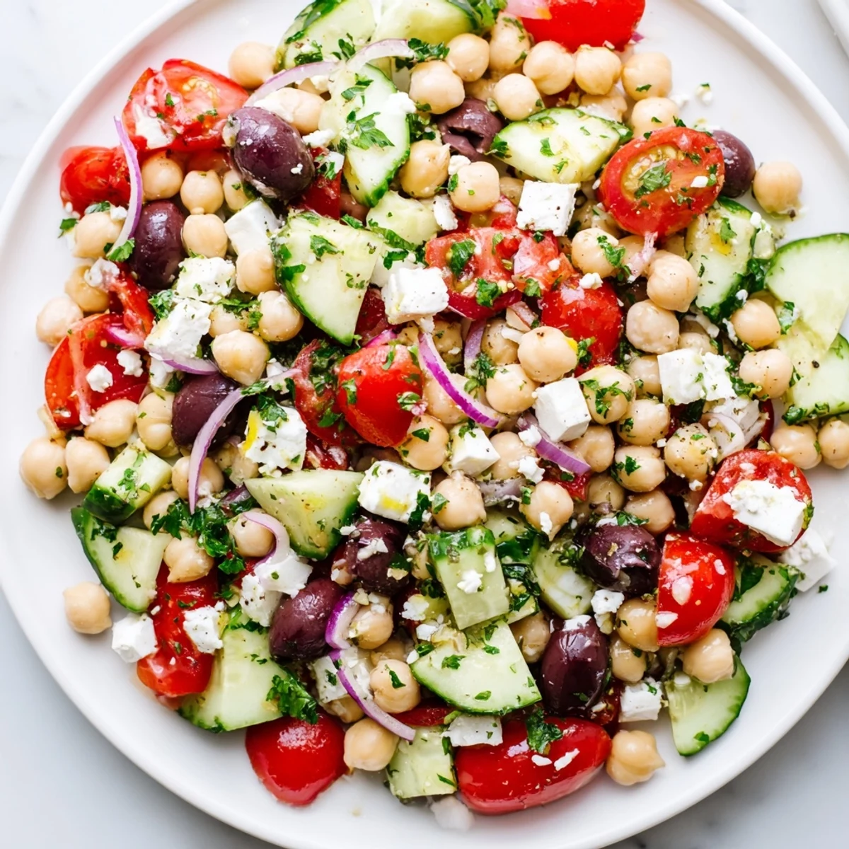 Close-up of a colorful Mediterranean Chickpea Salad, showcasing creamy feta and crisp cucumber pieces.