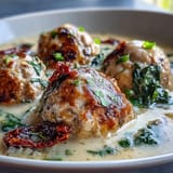 Creamy Tuscan Turkey Meatball Soup is served in a rustic bowl garnished with fresh basil, ready to enjoy alongside crusty artisan bread.