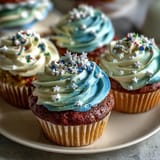 Fluffy Gemini Birthday Cupcakes topped with vibrant dual-tone frosting swirls.