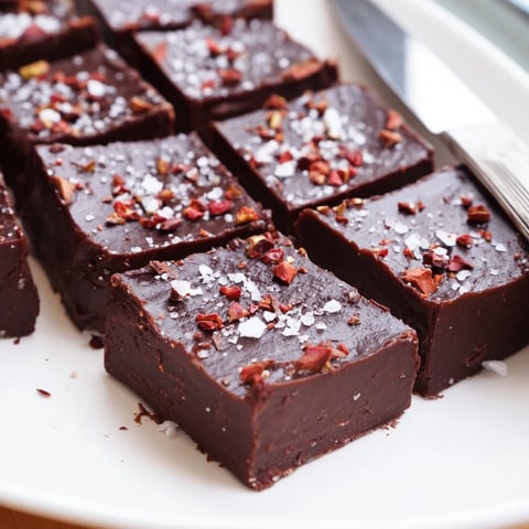 Decadent chocolate chili fudge bars topped with nuts, offering rich, spicy flavor.  