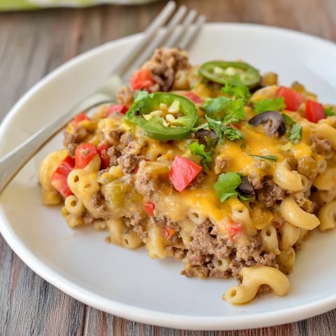 Creamy Taco Mac and Cheese Bake bubbling with melted cheese and colorful toppings.  