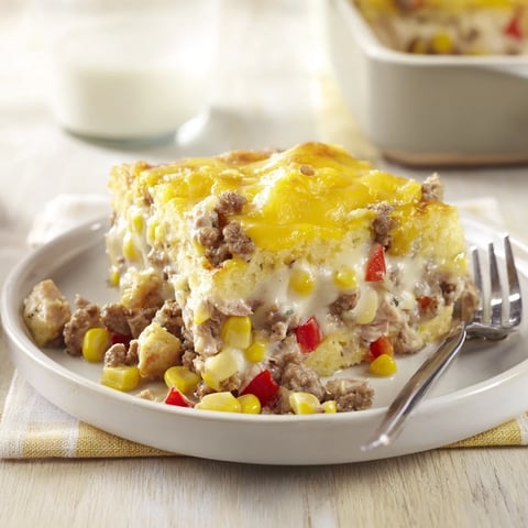 Golden Cheesy Cornbread Chicken Bake, a hearty casserole topped with melty cheese.  