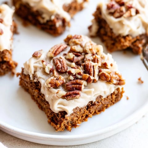 Warm, frosted pumpkin bars, a fall dessert featuring delicious brown sugar frosting up close.