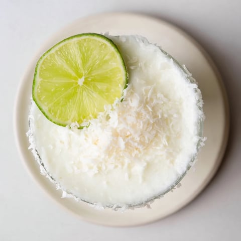 Creamy White Christmas Margarita Slush, a frosty blend of coconut, tequila, and lime, ready to serve.