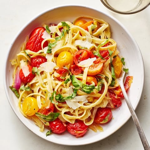 Steaming Cozy Fireplace One-Pan Tomato Basil Pasta with vibrant red tomatoes and fresh basil.