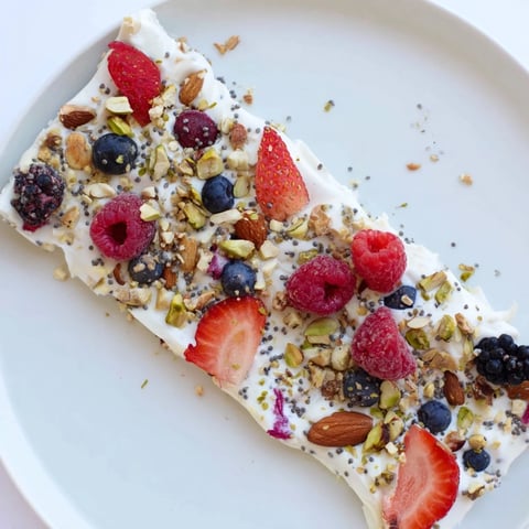 Frozen Fruit Yogurt Bark, a vibrant frozen treat studded with berries and crunchy granola.