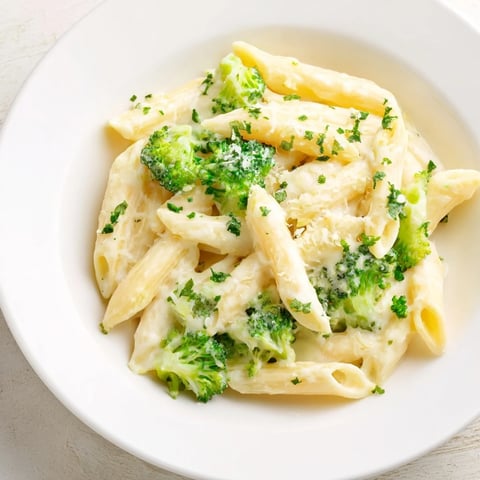 Steaming Cream Cheese Garlic Pasta with broccoli, a comforting bowl of creamy, cheesy goodness.