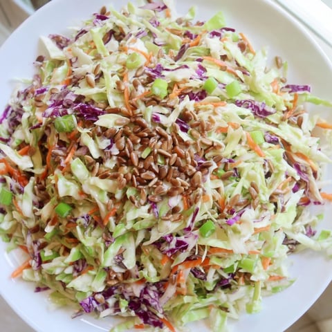 Fresh crunchy coleslaw salad with vibrant shredded cabbage, carrots, and creamy dressing.