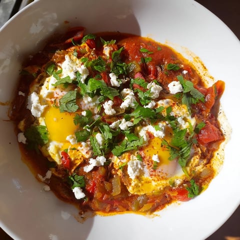 Israeli Shakshuka with brilliantly red tomato sauce and perfectly poached eggs.