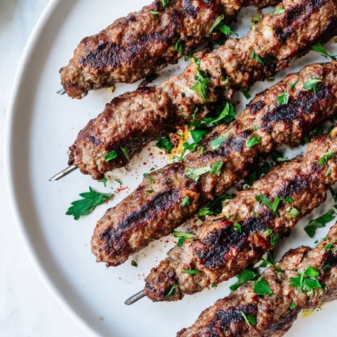 Sizzling Iraqi Kebab Tikka skewers, perfectly grilled with a delicious smoky char and served on flatbread.