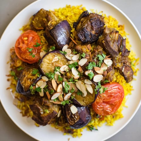 Fragrant Palestinian Maqluba, a beautifully flipped rice dish showcasing tender lamb and layered vegetables.