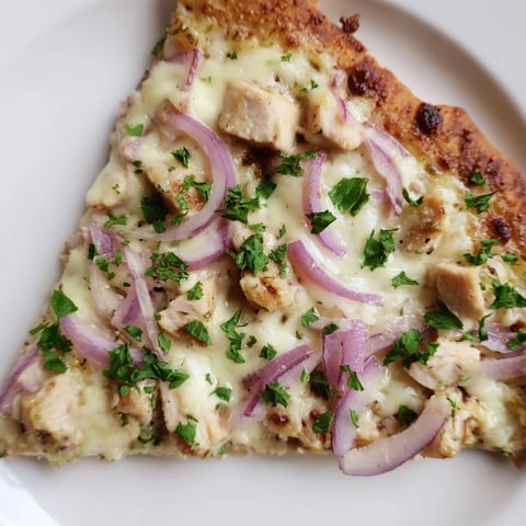 Golden crust of Chicken Alfredo Pizza glistening with melted mozzarella and Parmesan, topped with tender chicken pieces.