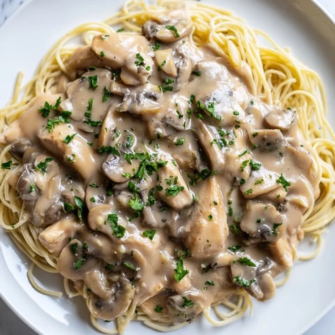 Creamy Mushroom Chicken Spaghettini features tender chicken strips and al dente pasta tossed in a velvety mushroom sauce.  