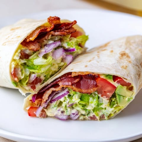 Crispy bacon and fresh veggies fill these Zesty BLT Wraps with chipotle mayo on a tortilla.