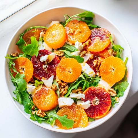 This Winter Citrus & Candied Pecan Salad offers a close-up view of the ingredients before being tossed.