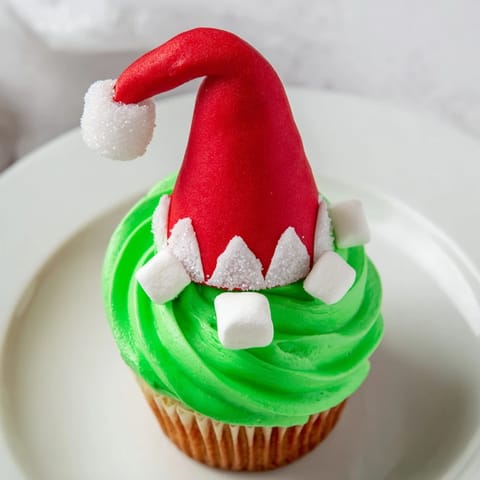 Delicious Elf Hat Cupcake Tower: festive cupcakes with bright frosting and elf hat decorations, perfect for celebration.