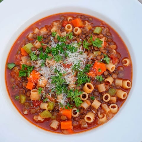 Close-up of a creamy bowl of Ditalini and Lentil Soup, full of tender lentils and pasta.