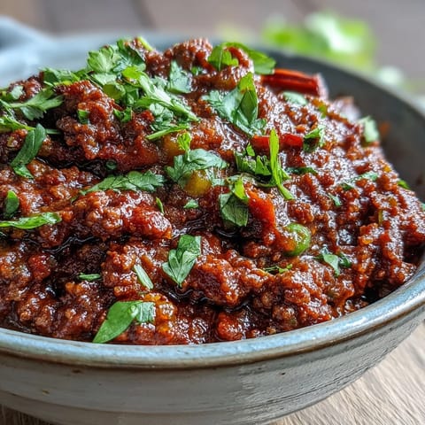 Steaming bowl of homemade Venison Keema Curry featuring ground venison, peas, and golden onions. Ready to serve alongside fluffy basmati rice for a cozy gluten-free dinner.