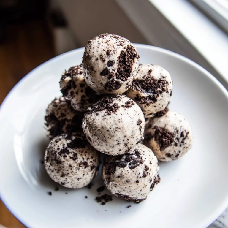 Enjoy a close-up of delicious Cream Cheese Oreo Protein Balls, perfect for a quick and healthy dessert.