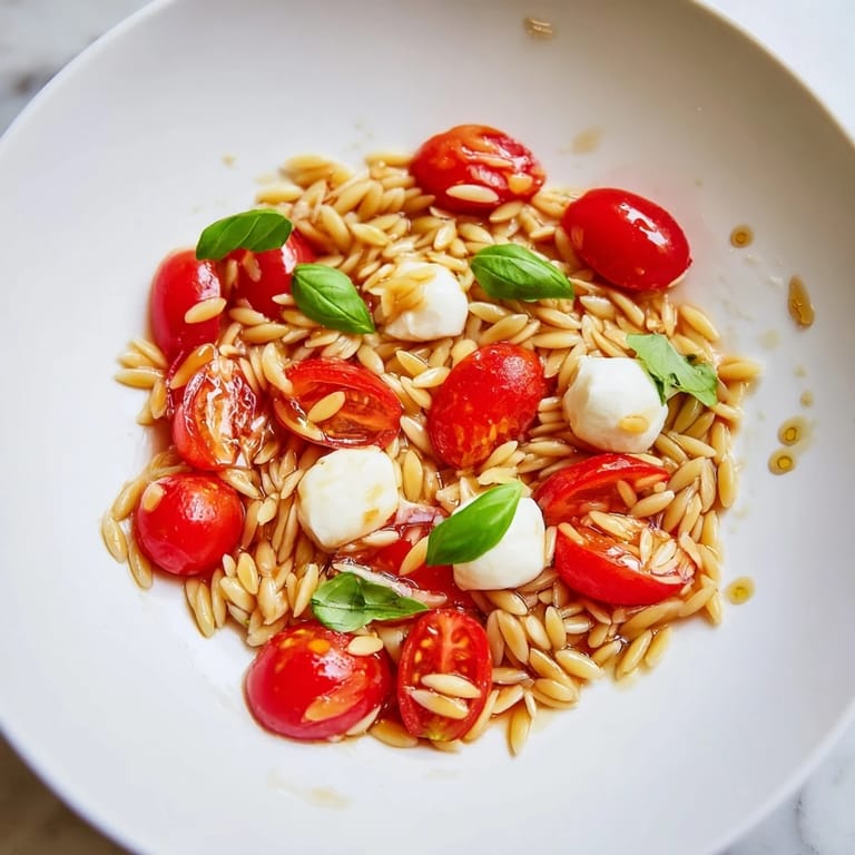 A bowl of delicious Caprese Orzo Salad, a light and refreshing Italian-inspired meal.