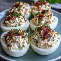 Creamy smoked salmon deviled eggs topped with everything bagel seasoning and fresh chives, perfect for brunch or parties.