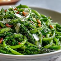 Shaved asparagus salad with lemon and Parmesan, a fresh spring dish with citrus zest and cheese shavings.  