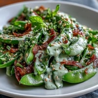 Vibrant Snap Pea and Radish Spring Salad with creamy tahini dressing.